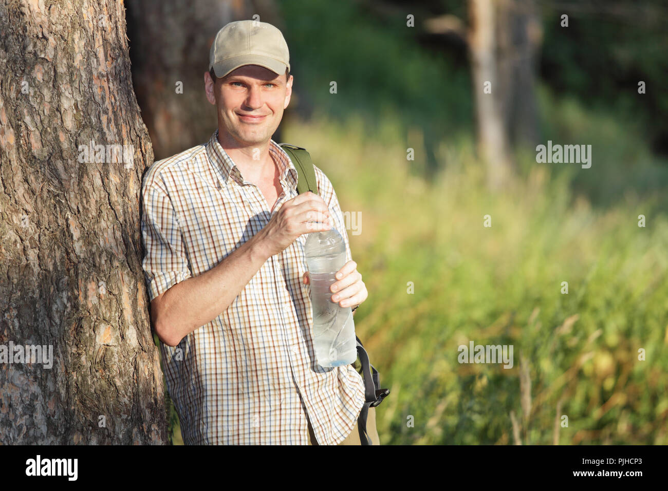 Tourist drinking water in the forest Stock Photo Alamy