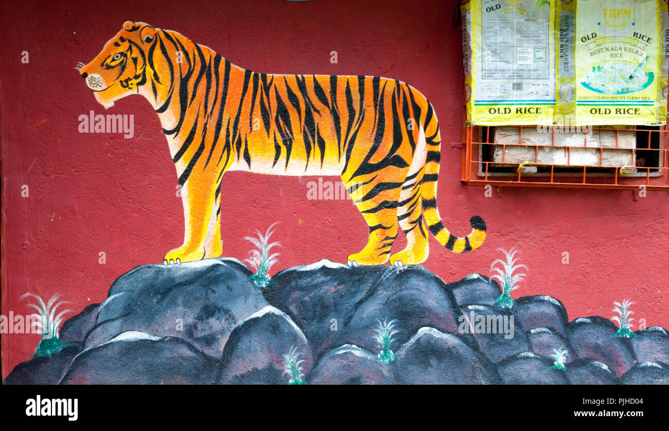 MUMBAI, INDIA – August 9 2018: Tiger painted on the wall of a Warli temple.  Warli are indigenous tribal people. In Mumbai at SGNP they live alongside Stock Photo