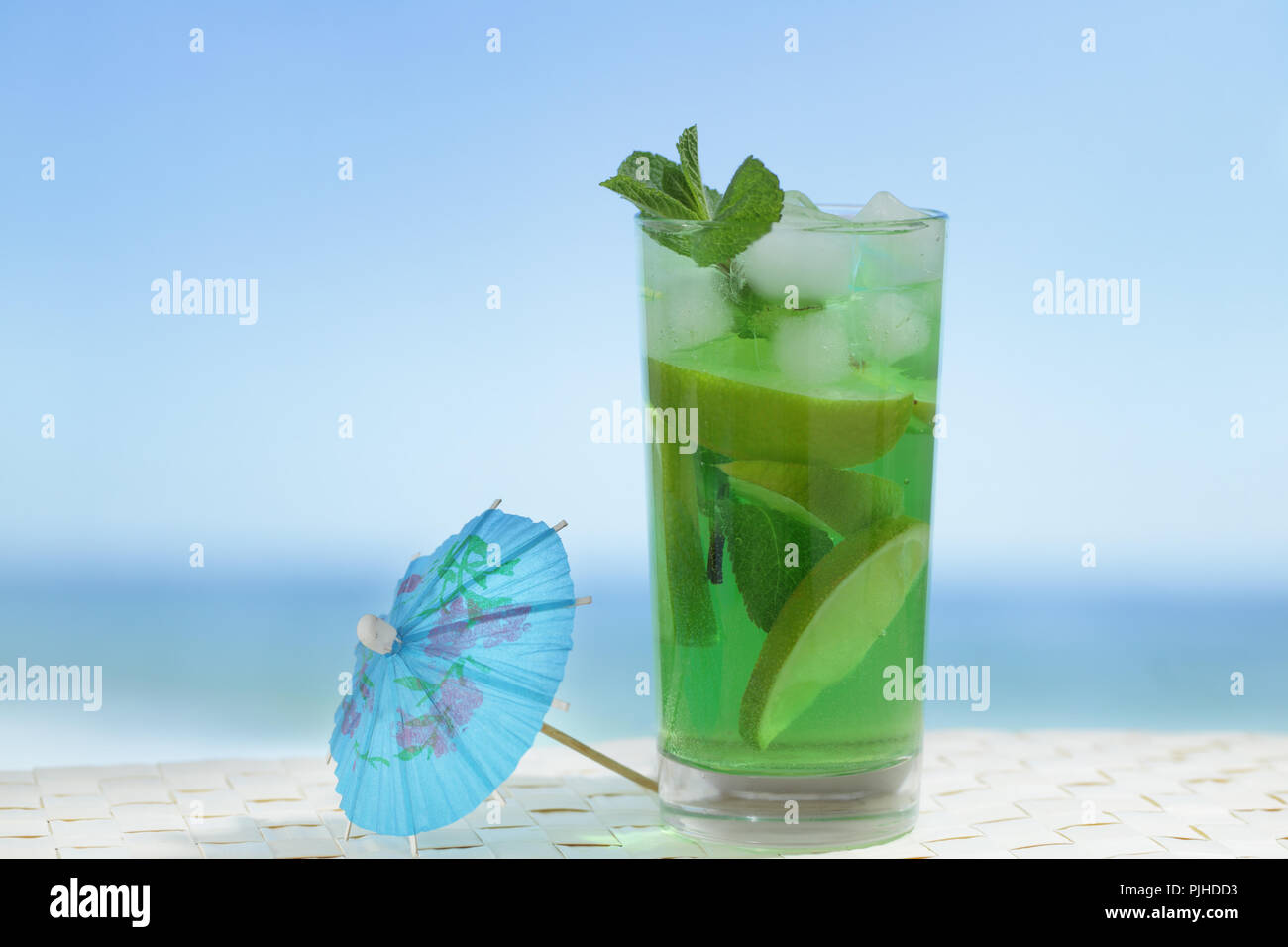 Mojito cocktail in the highball glass against the sea Stock Photo