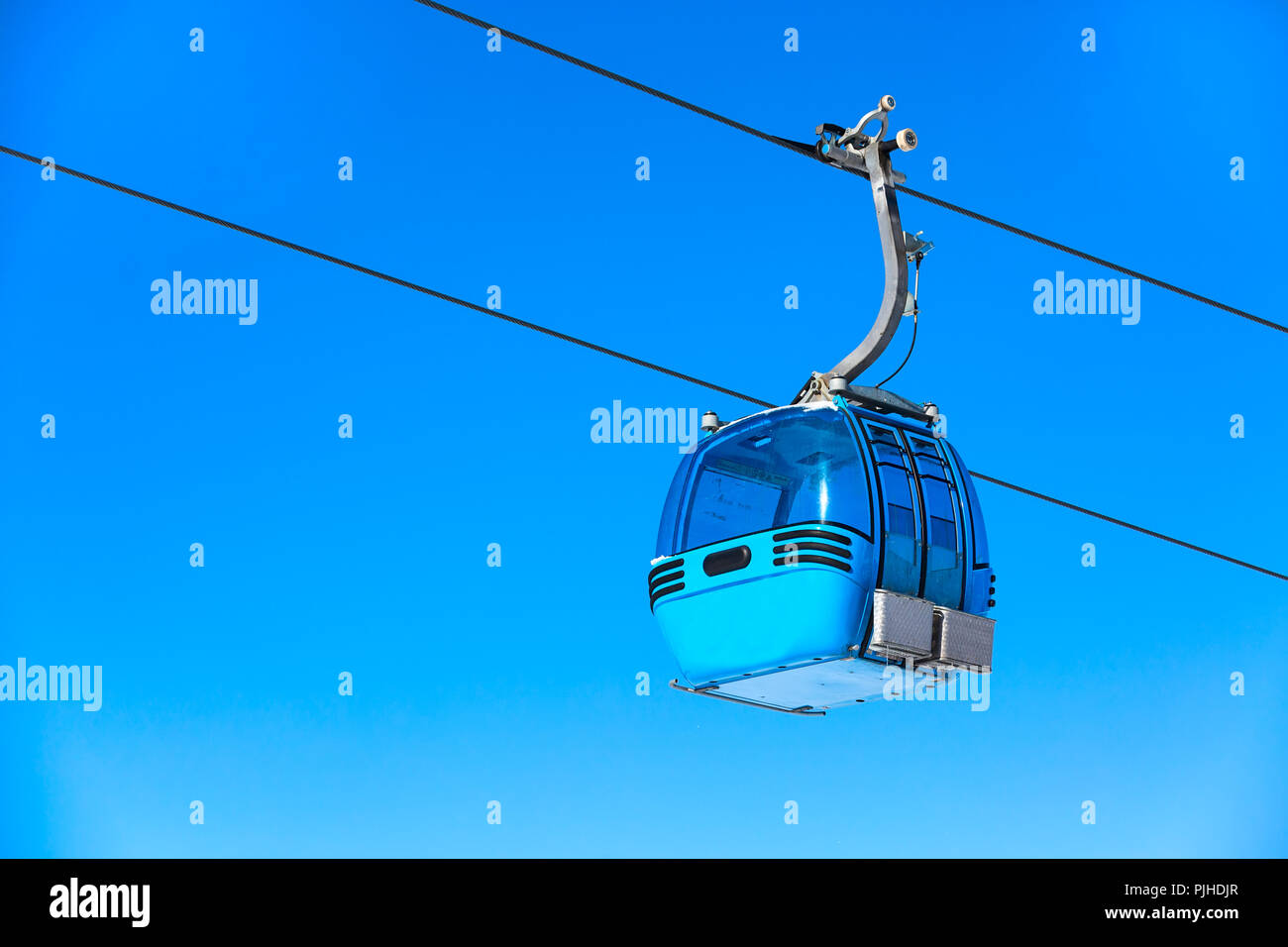 Blue cable car cabin ski lift and blue sky at the background Stock ...