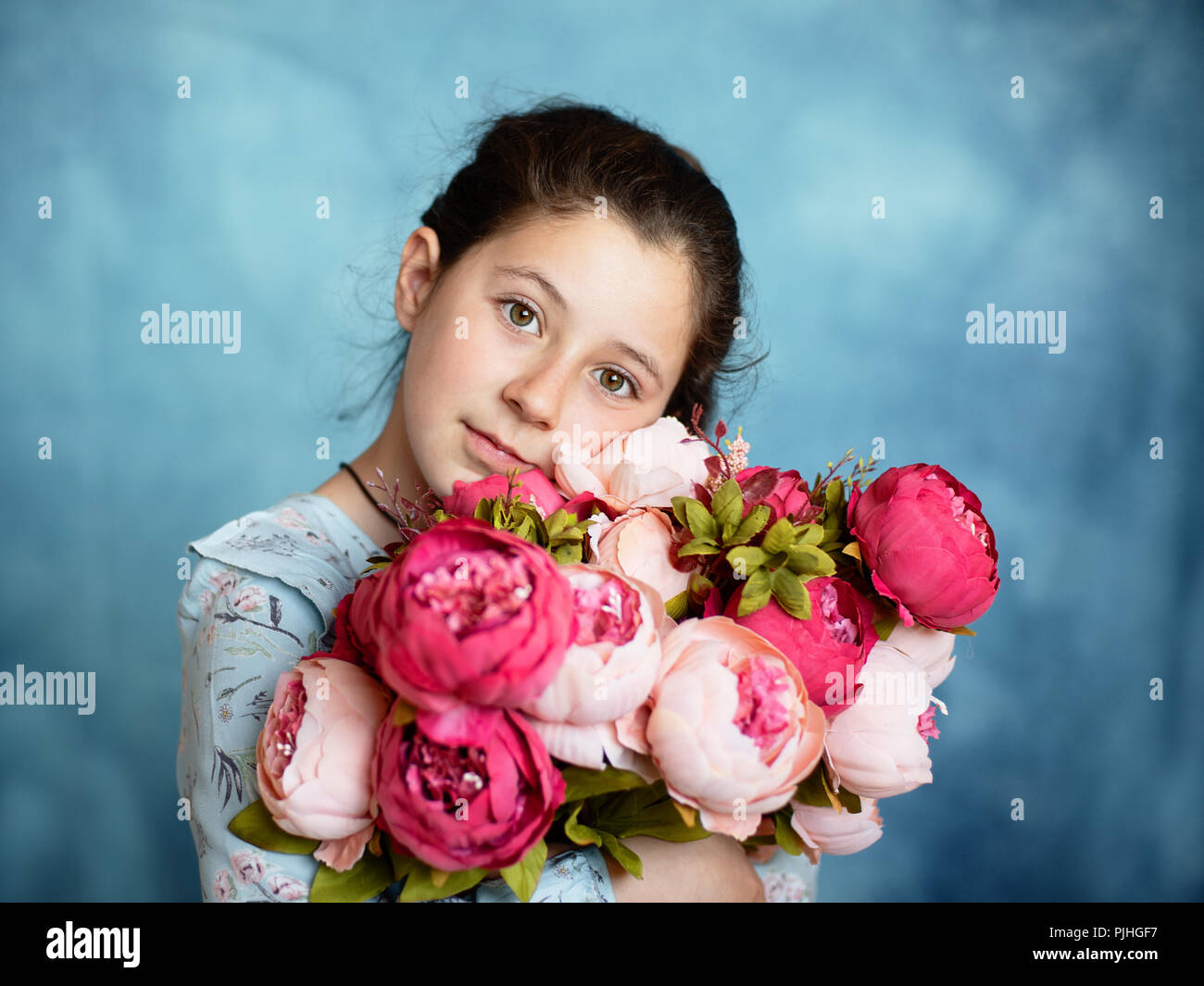 Little cute girl with a bouquet of flowers in the studio Stock Photo ...