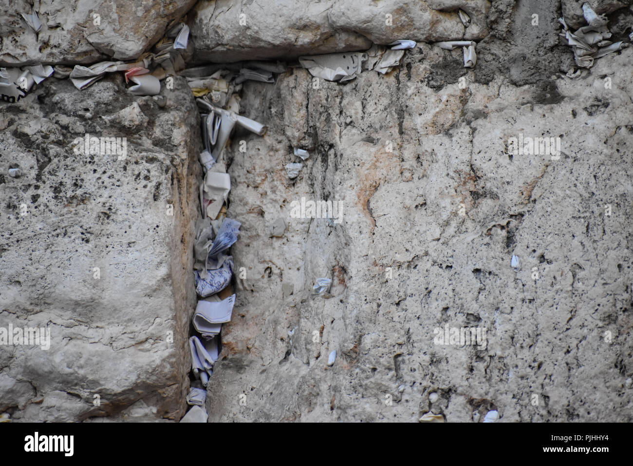 Notes stuffed into crevices in the Western Wall in the Old City of Jerusalem Stock Photo