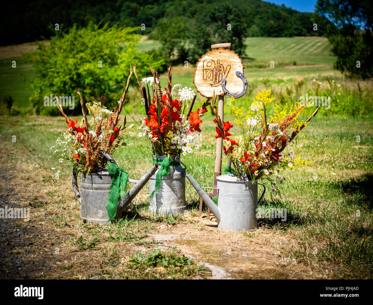 the sign for the party with flowers and watering can in summer and spring autumn Stock Photo