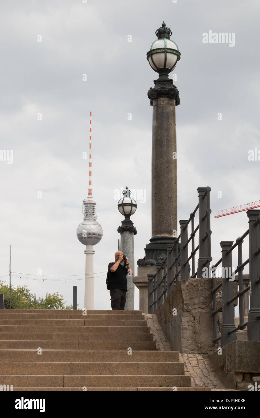 Berlin, Germany - September 5, 2018: View of the television tower, landmark of Berlin, and old street lamps with passers-by on the photo, Germany. Stock Photo