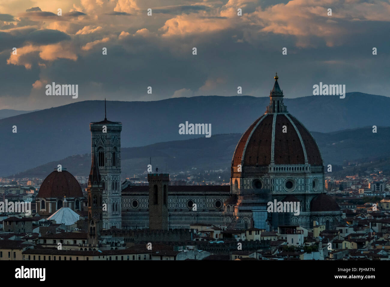 Cathedral of Santa Maria del Fiore towers above the cityscape at dusk ...