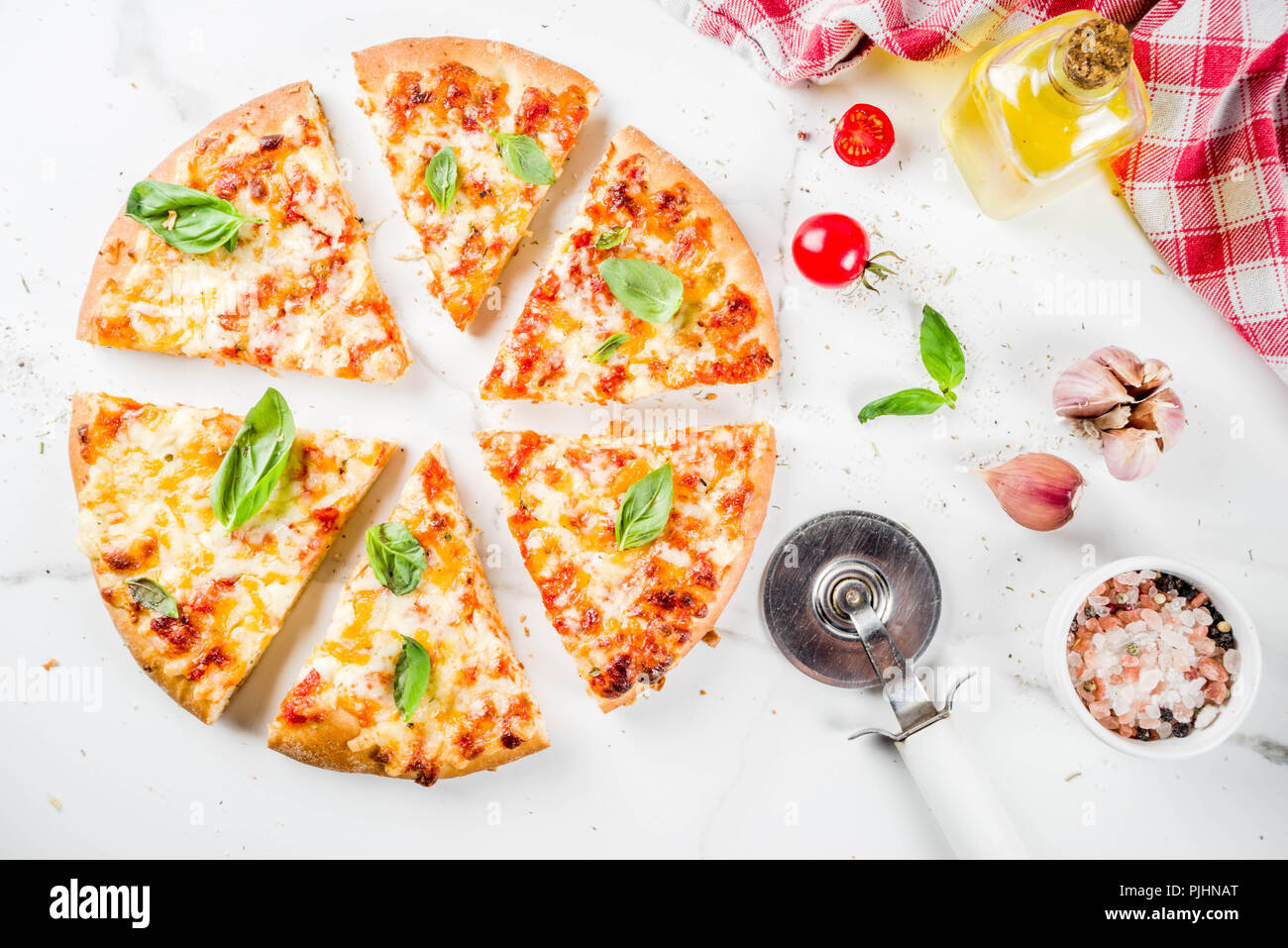 Homemade sliced cheesy classic italian pizza with ingredients and olive