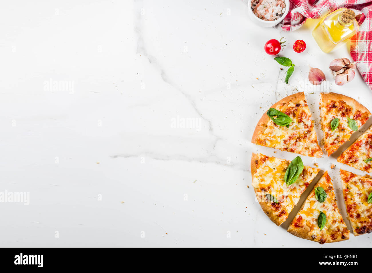 Homemade sliced cheesy classic italian pizza with ingredients and olive