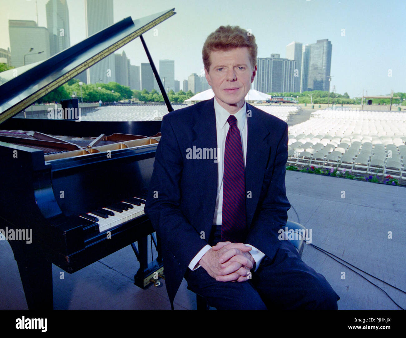 Pianist Van Cliburn poses with his piano in the Petrillo Music Shell in Grant Park in Chicago, Illinois, USA , ca. 1990. Stock Photo