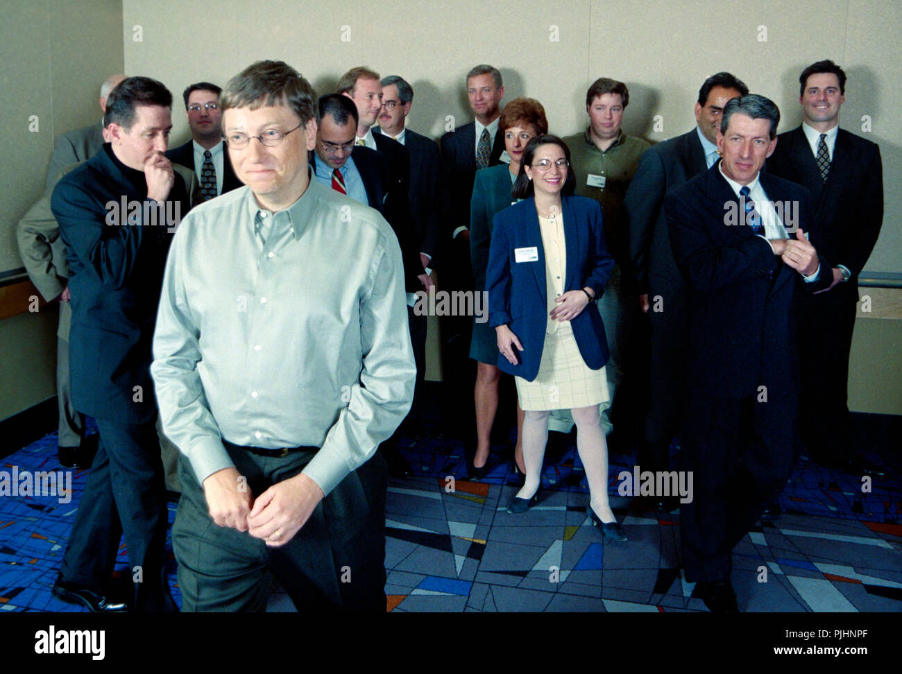 CEO and Microsoft President Bill Gates walks away from a group of sales reps after team picture, ca. 1990. Stock Photo