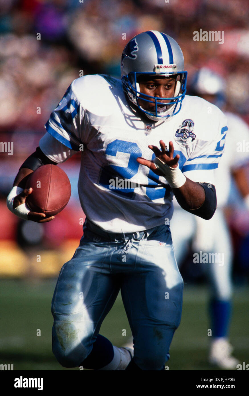 Detroit Lions Hall of Fame NFL running back Barry Sanders evades tacklers during a football game  against the Green Bay Packers in 1993. Stock Photo