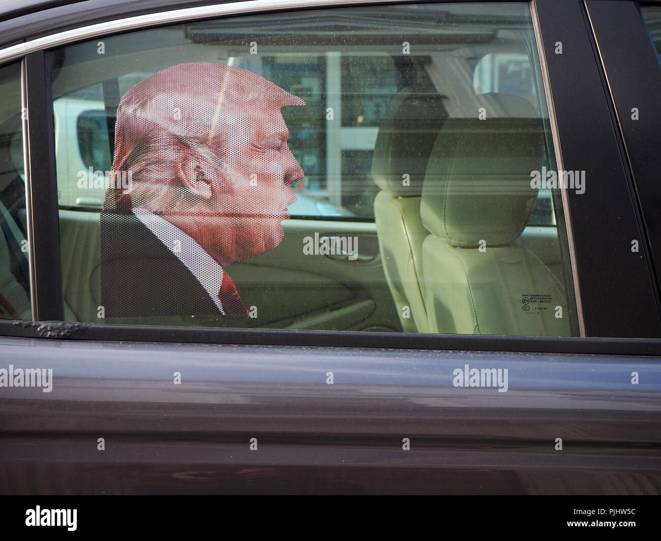 Donald Trump being chauffeured in the back of a car Stock Photo