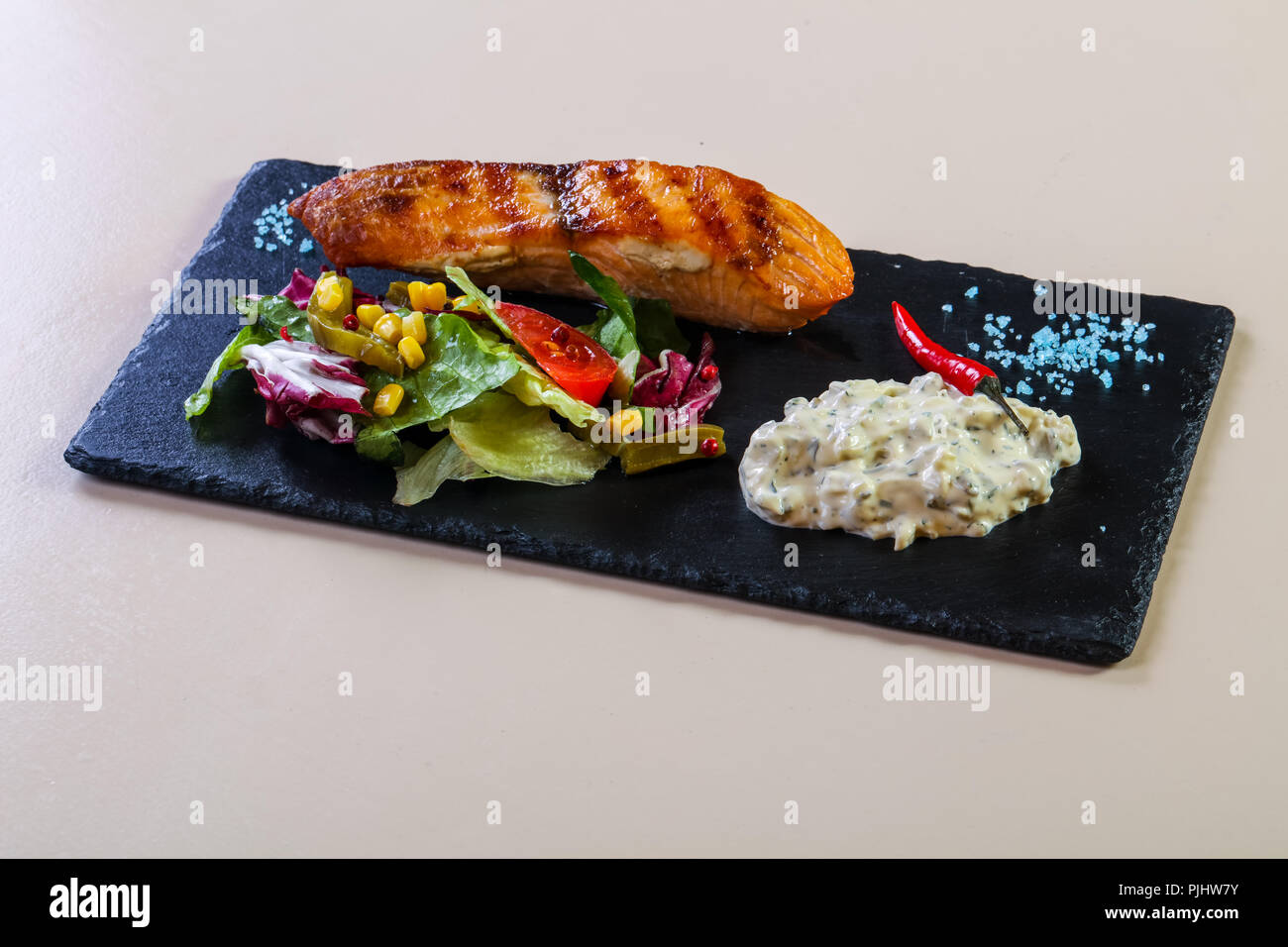 Grilled salmon steak with sauce Stock Photo - Alamy