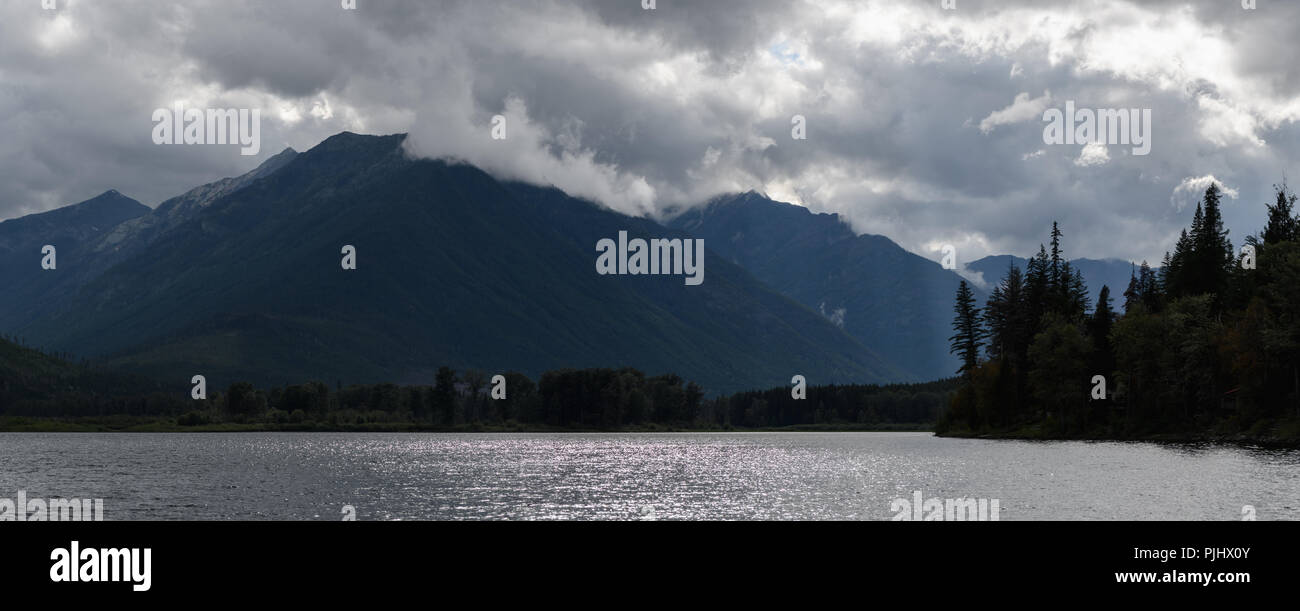 Panorama of Misty dramatic sky over mountains Stock Photo