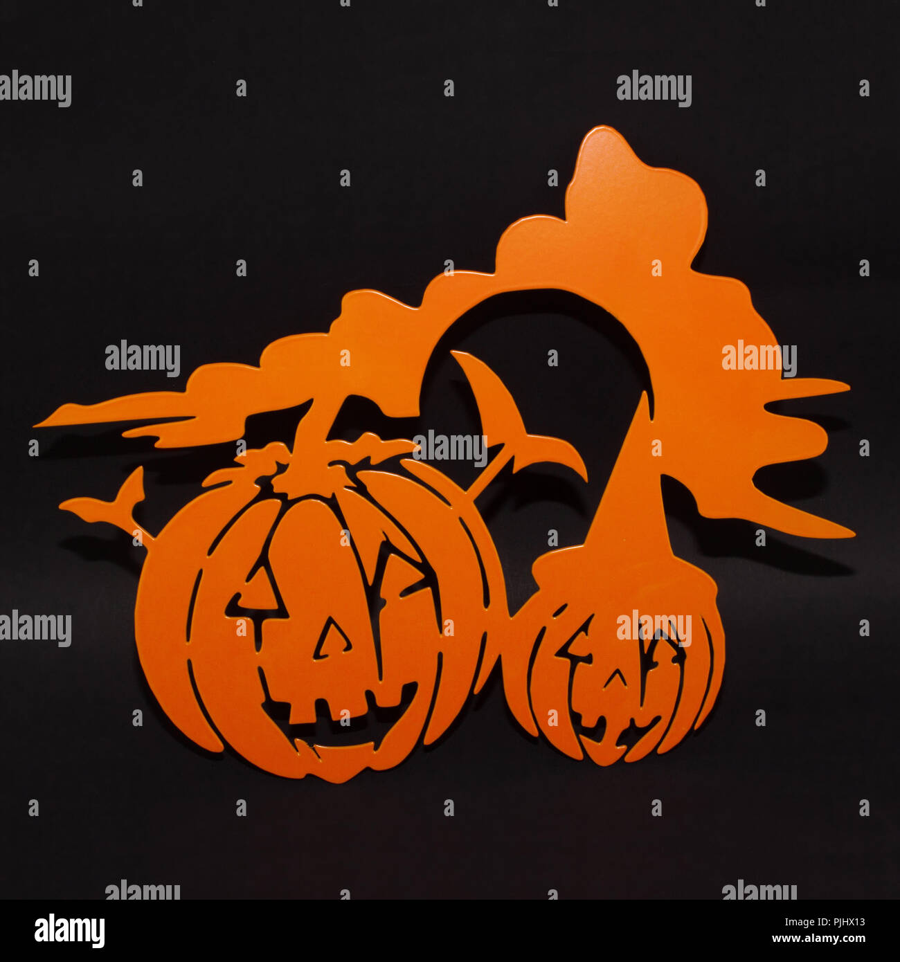 Halloween background decoration holiday concept. Two orange pumpkins angry faces shadow and silhouette on black background Stock Photo
