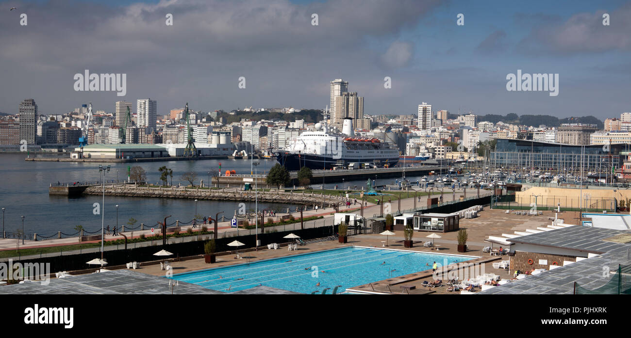 Spain, Galicia, A Coruna, swimming pool of Hotel NH Collection A Coruña Finisterre, by harbour with MV Marco Polo moored, panoramlc Stock Photo