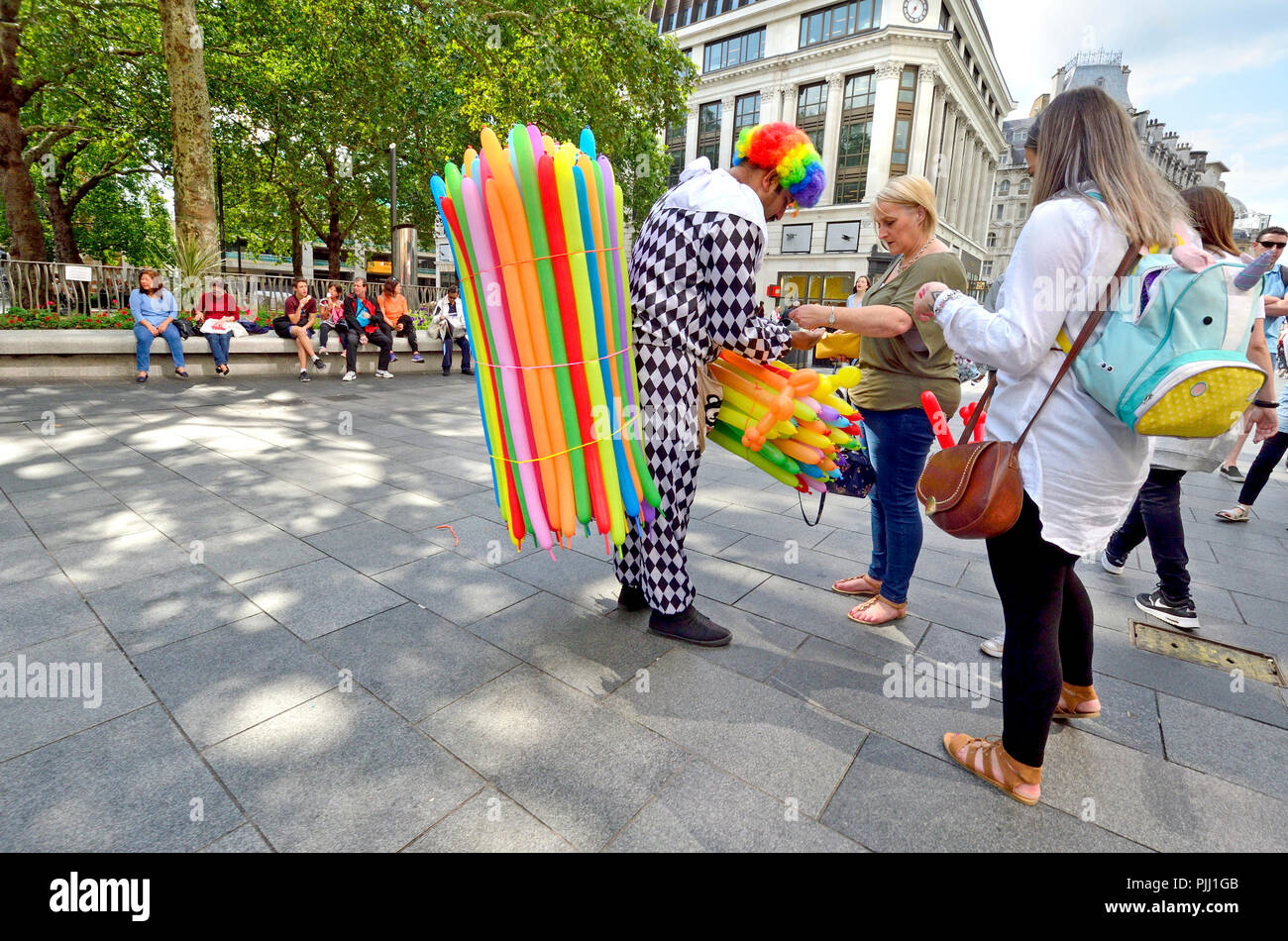 Clown selling balloon animals in Leicester Square, London, England, UK ...