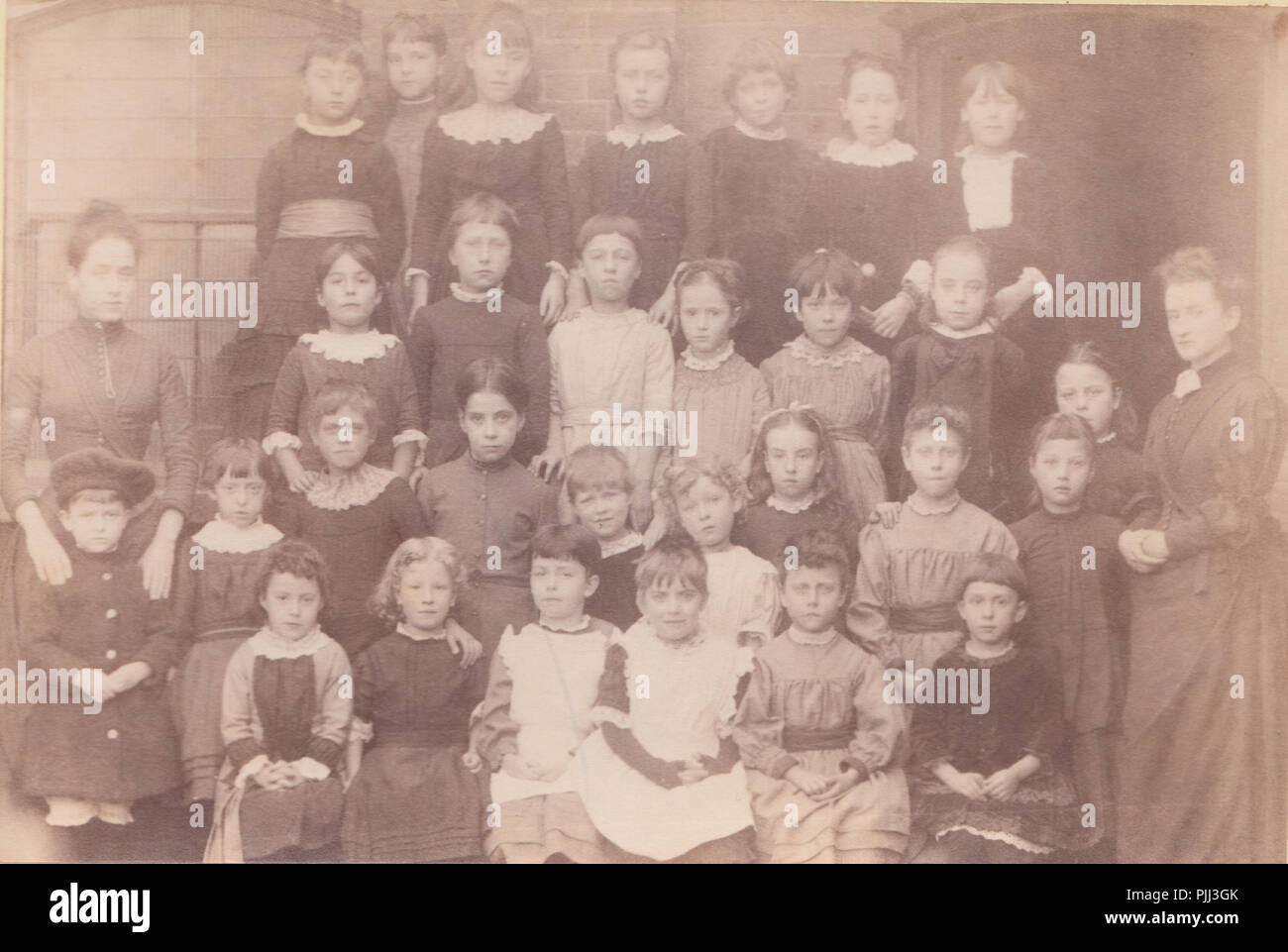 Victorian Hammersmith, London Cabinet Card of Teachers Posing With Their School Children Stock Photo