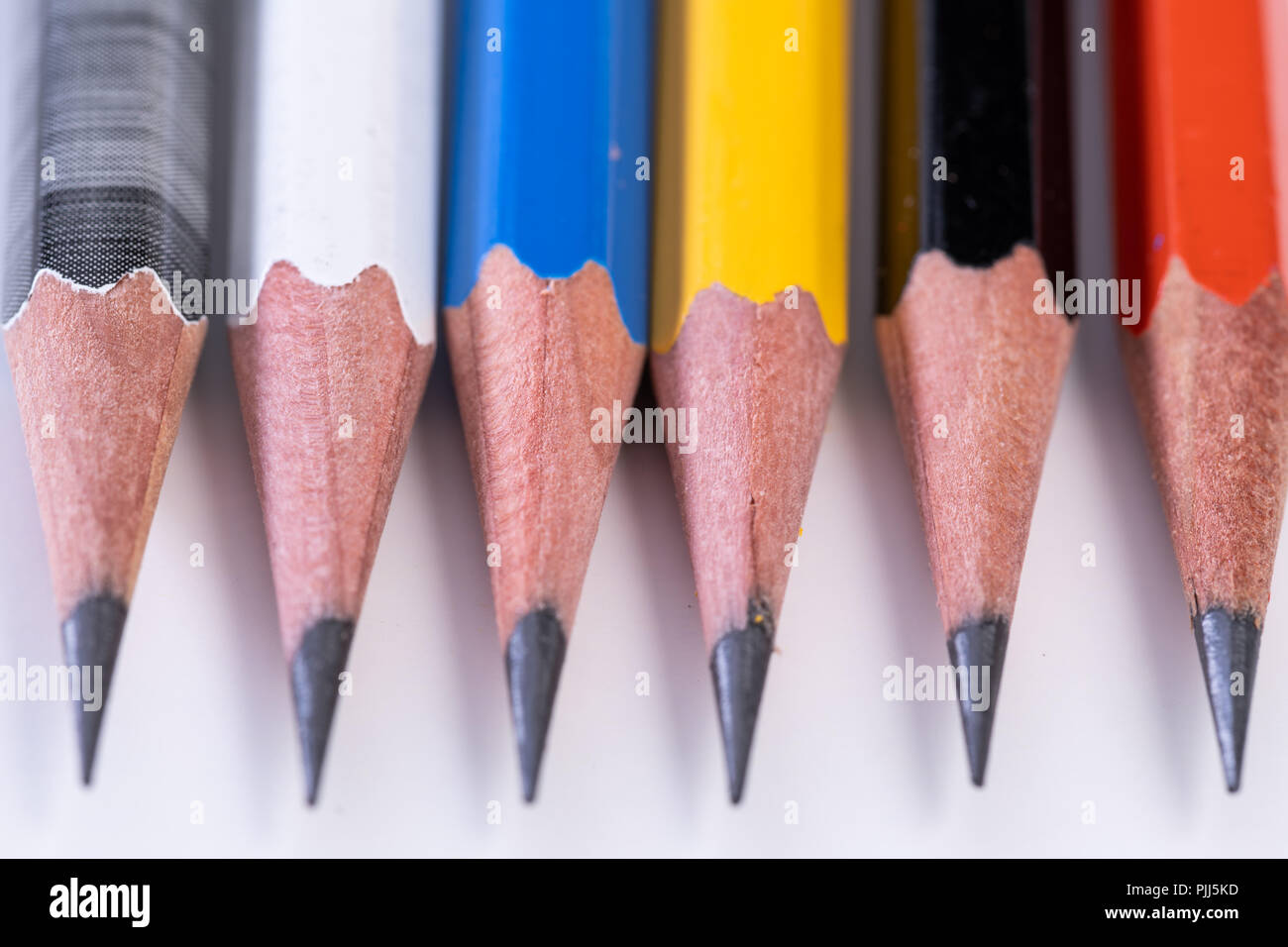 Several sharp new lead graphite pencils of various colors and patterns