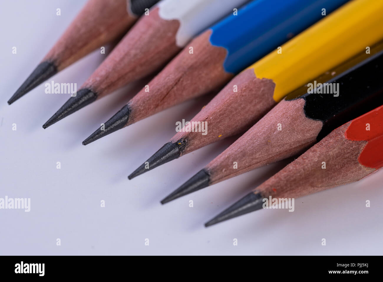 Several sharp new lead graphite pencils of various colors and patterns Stock Photo