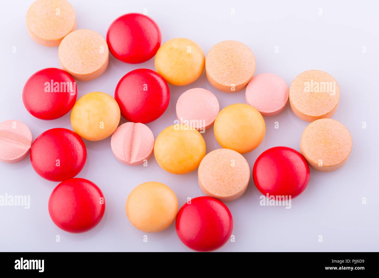 Tablets pills capsule heap mix therapy drugs, over a white background