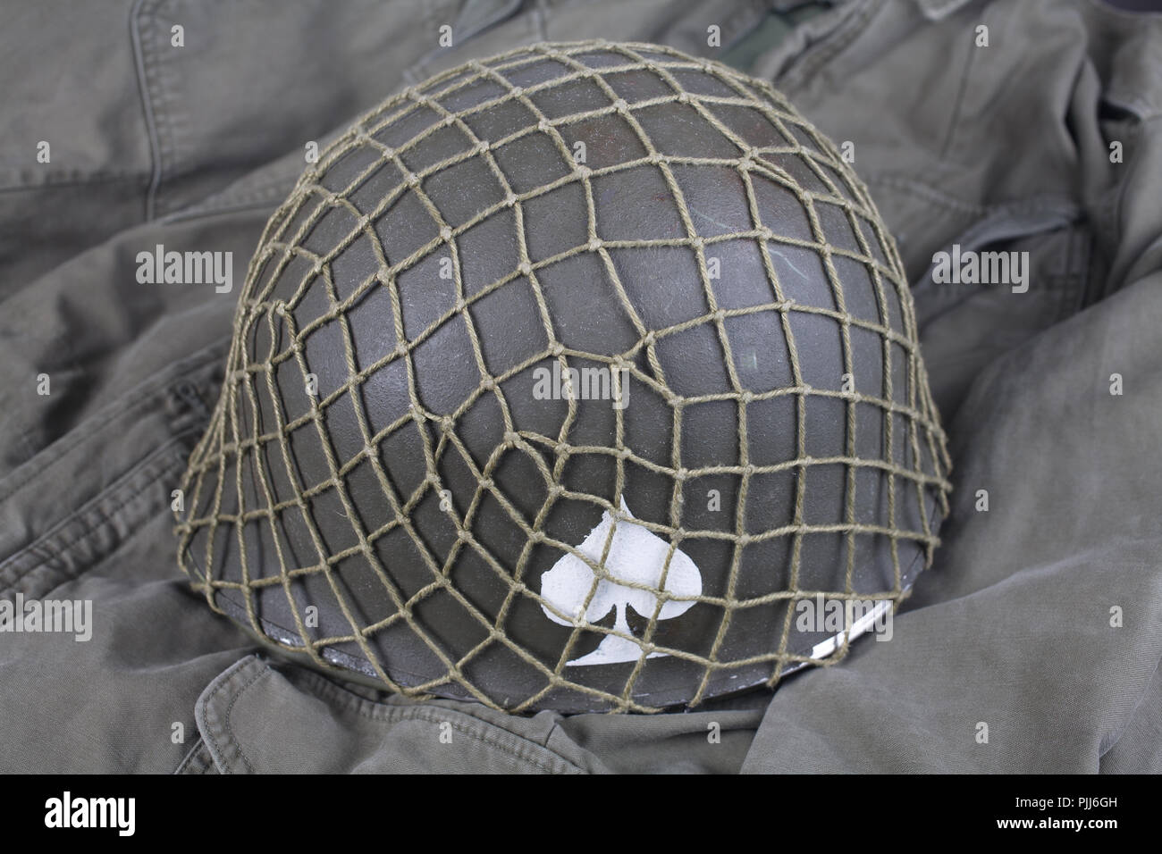 ww2 us army pistol belt and helmet with ace of spades emblem on green ...