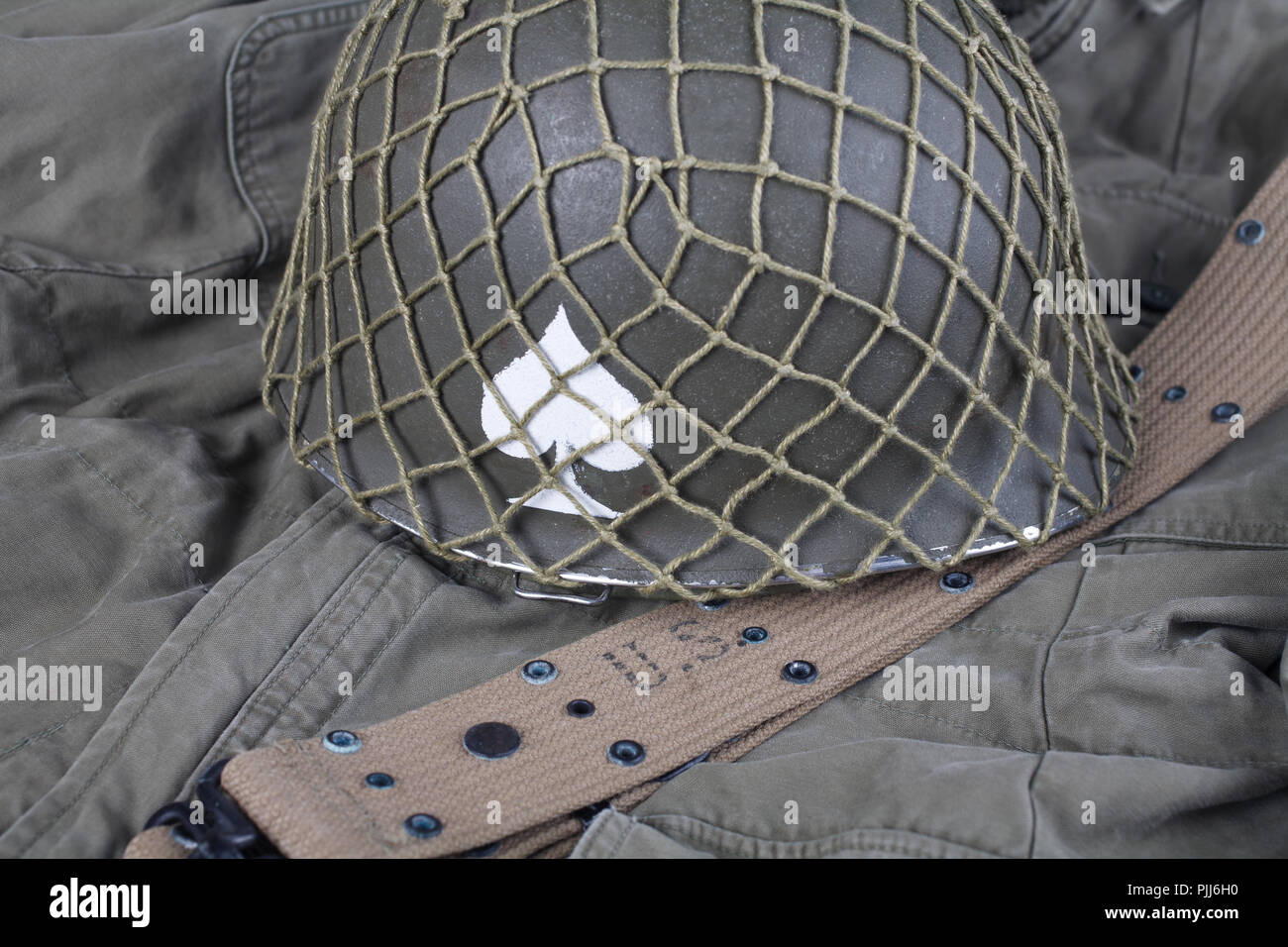 ww2 us army pistol belt and helmet with ace of spades emblem on green ...