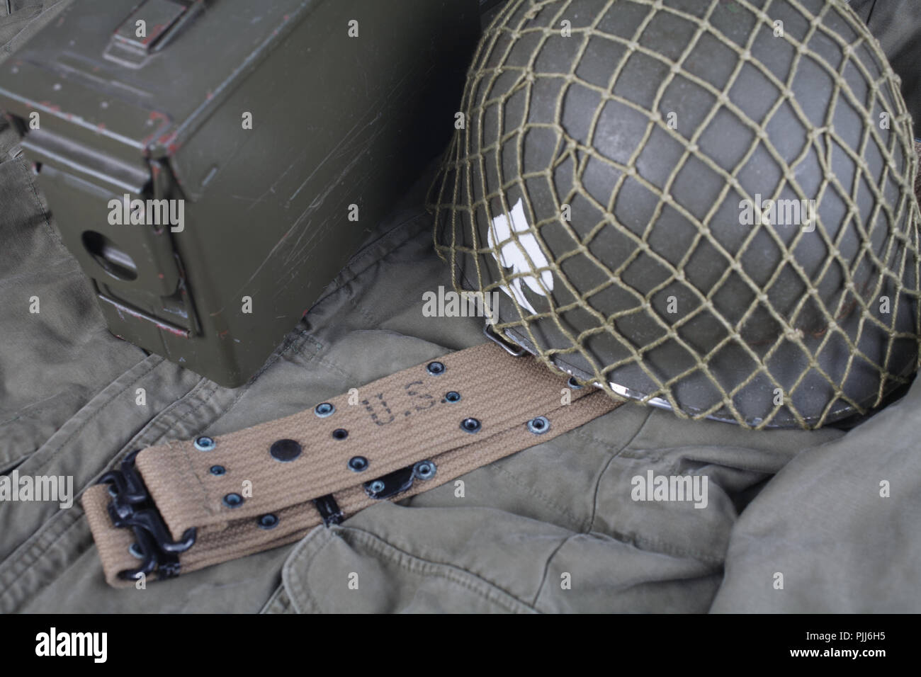 ww2 us army pistol belt and helmet with ace of spades emblem on green ...