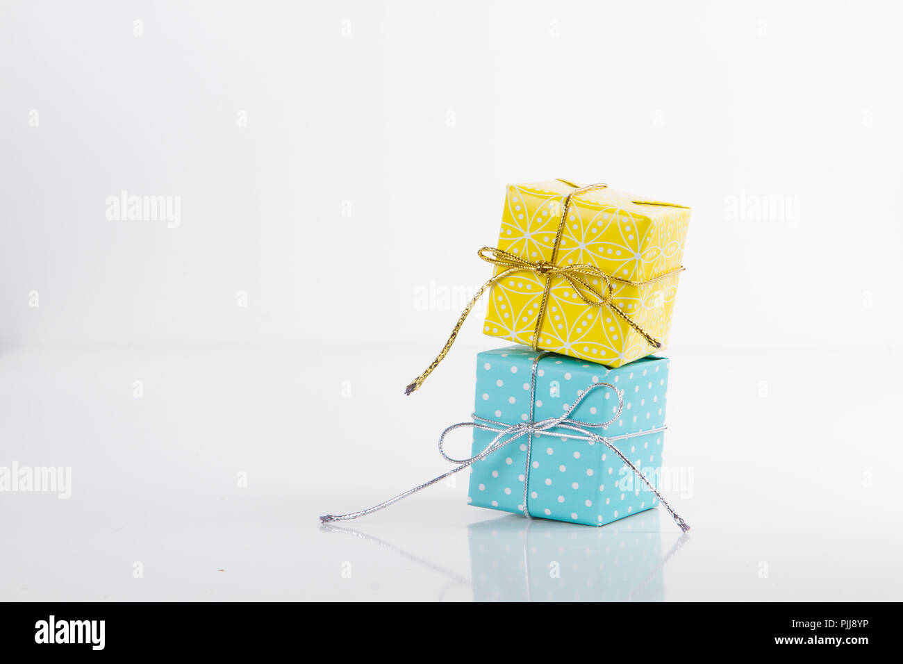 Two gift boxes wrapped in different colored paper Stock Photo