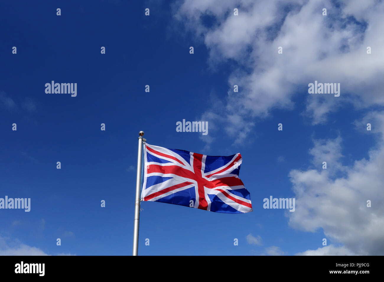 Union Jack Flag flying in the wind on a sunny day in England Stock Photo Alamy