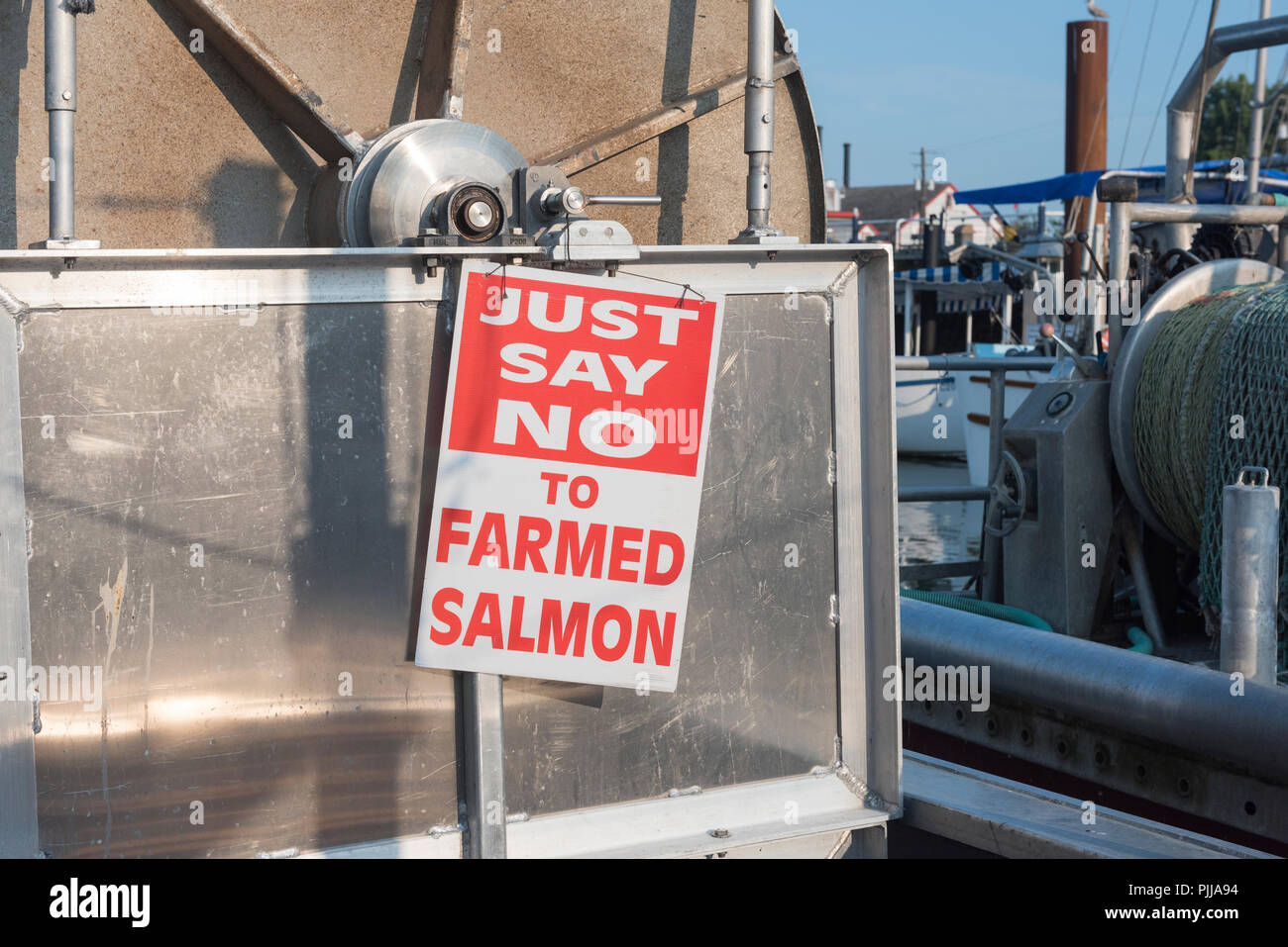 Fishing boat displaying sign against farmed fish, Steveston, British Columbia. Stock Photo