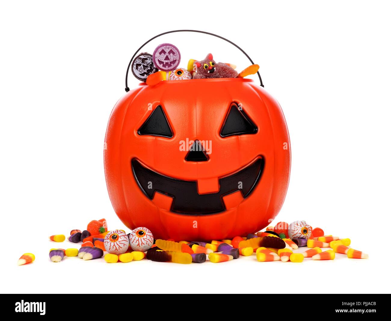 Black Halloween Jack o Lantern candy collector with scattered candy over a  white background Stock Photo - Alamy