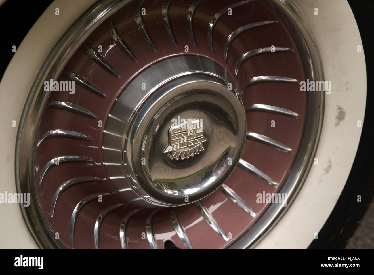 Close up of a hub cap from an antique vintage car. Tire of an
