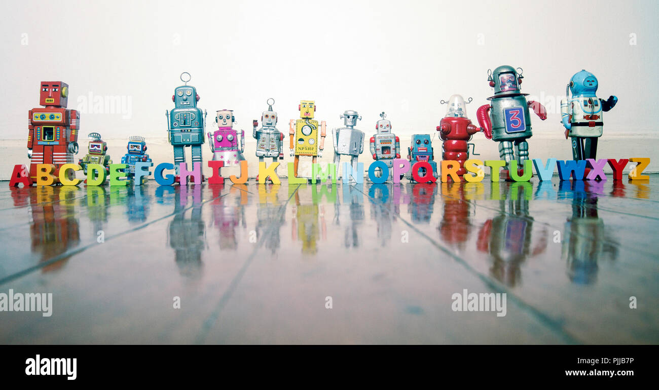 Alphabet Robots Standing On A Wooden Floor With Reflection Stock Photo Alamy