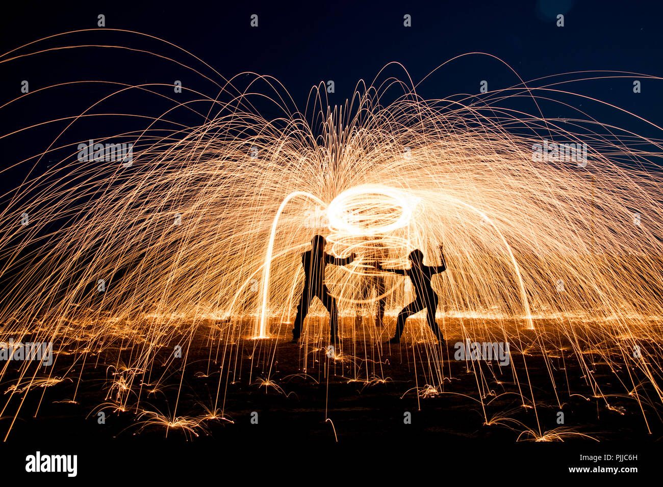 Sparks and flames long exposure steel wool night photography. Stock Photo