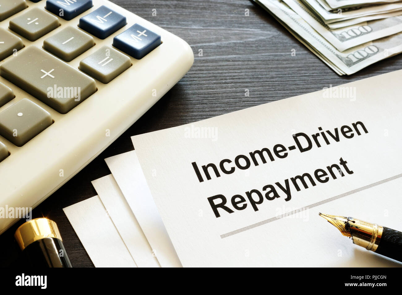 Income Driven Repayment. Papers, calculator and money Stock Photo - Alamy