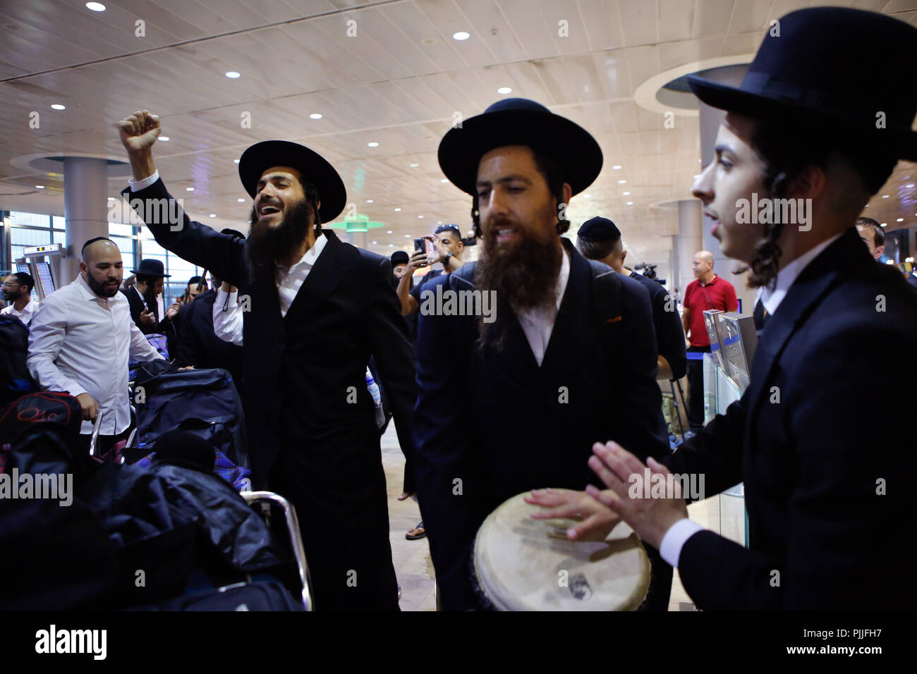 Tel Aviv, Israel. 6th Sep, 2018. Ultra-orthodox Jewish men from Breslov sect dance and sing as they check in to flights headed for Ukrainian city of Uman at Ben-Gurion International Airport near Tel Aviv, Israel, on Sept. 6, 2018. On the Jewish New Year in September, tens of thousands of religious Jews will fly to Uman to pray at the grave of Rabbi Nachman of Breslov, who founded the Hasidic Jewish movement named after him at the end of the 18th century. Credit: Gil Cohen Magen/Xinhua/Alamy Live News Stock Photo