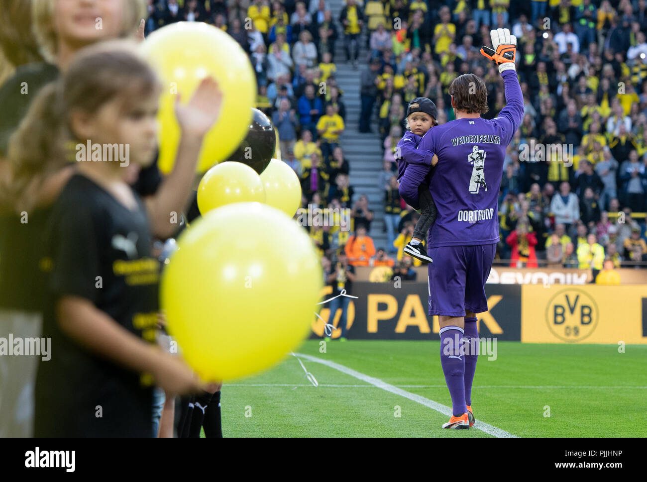 Dortmund, Germany. 07th Sep, 2018. Soccer: Goalkeeper Roman Weidenfeller runs through the stadium with his son on his arm for his farewell match and waves. Credit: Bernd Thissen/dpa/Alamy Live News Stock Photo