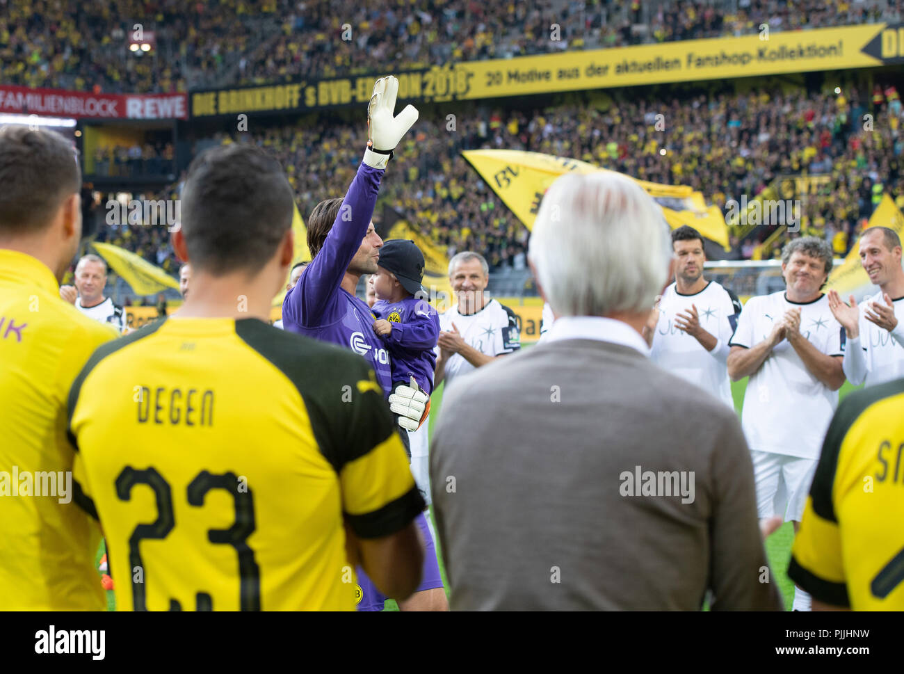 Dortmund, Germany. 07th Sep, 2018. Soccer: Goalkeeper Roman Weidenfeller walks through a trellis into the stadium for his farewell match with his son on his arm and waves. Credit: Bernd Thissen/dpa/Alamy Live News Stock Photo