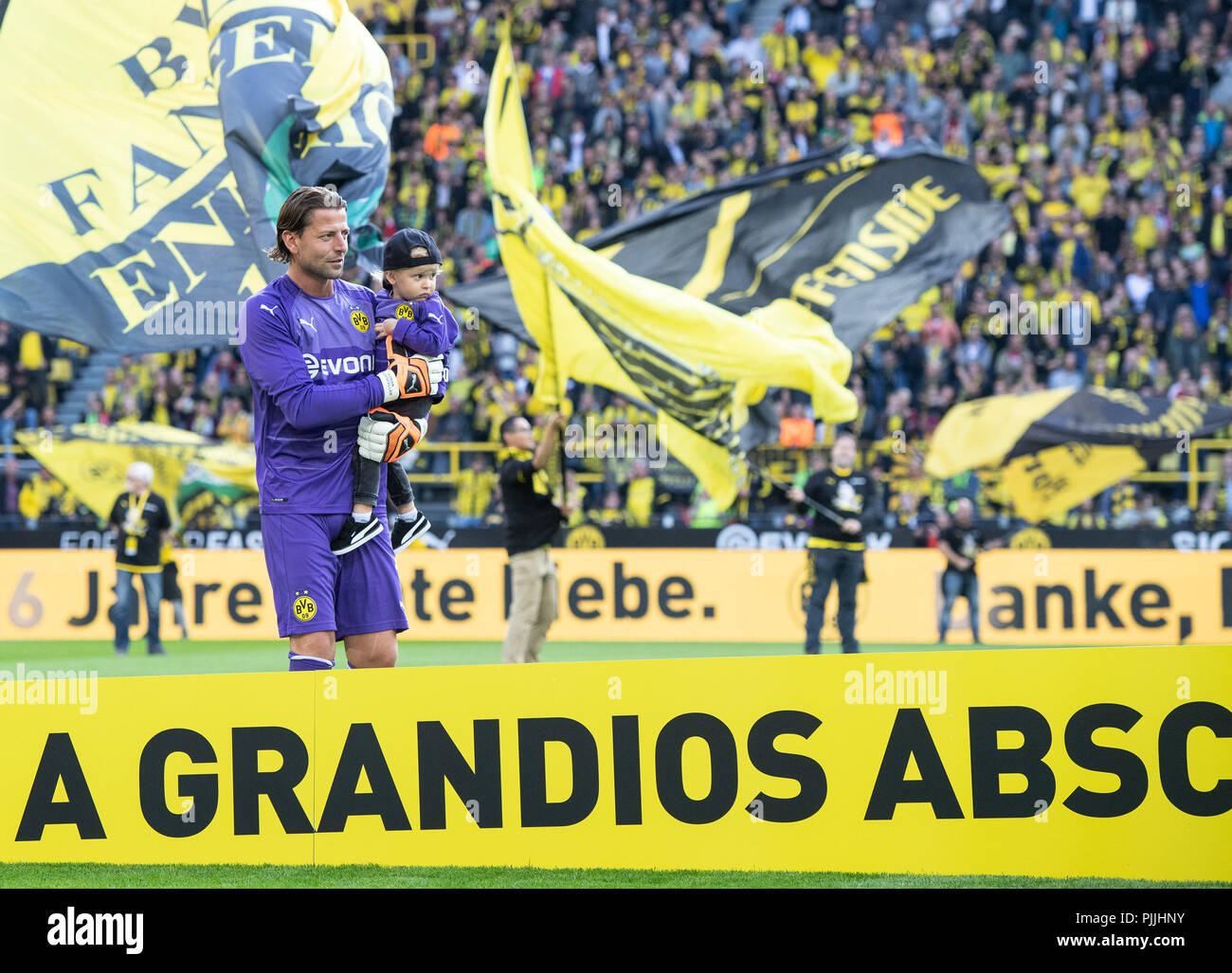 Dortmund, Germany. 07th Sep, 2018. Soccer: Goalkeeper Roman Weidenfeller runs through the stadium with his son on his arm for his farewell match. Credit: Bernd Thissen/dpa/Alamy Live News Stock Photo