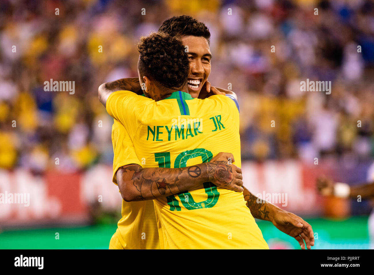 East Rutherford, NJ, USA. 7th Sept, 2018. Roberto Firmino (20) celebrates with Neymr (10) after scoring the opening goal in the USA vs. Brazil soccer friendly. © Ben Nichols/Alamy Live News Stock Photo