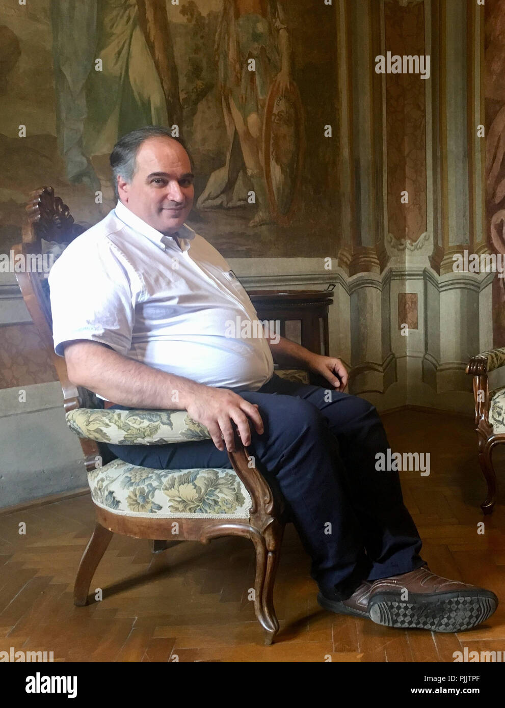 Frascati, Italy. 16th Aug, 2018. Luigi Miraglia, headmaster and founder of the Accademia Vivarium Novum, sits in a hall of Villa Falconieri. Here, near Rome, Latin and ancient Greek are anything but dead. (to dpa Ubi mortuae linguae vivunt - where dead languages live in Rome from 08.09.2018) Credit: Laura Krzikalla/dpa/Alamy Live News Stock Photo
