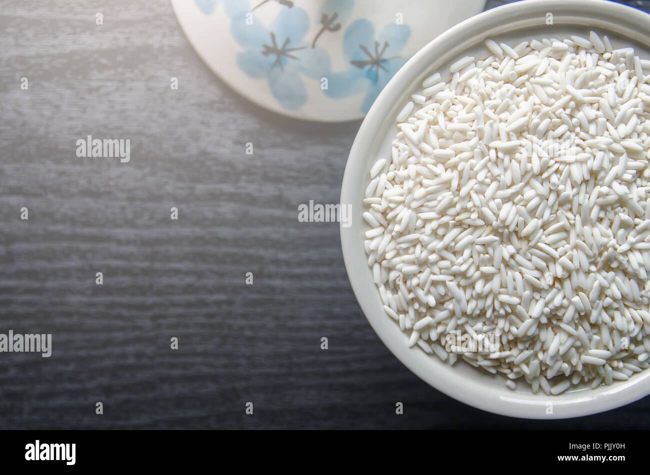 Top view of paddy rice and rice seed on dark wooden floor, Background ...