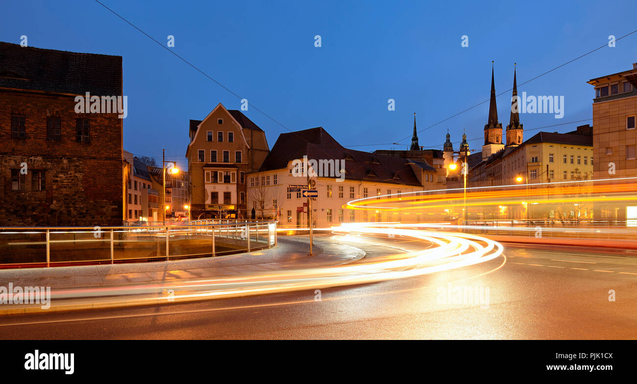 Germany, Saxony-Anhalt, Halle (Saale), dusk, light trails of tram and car, behind market church and Red Tower, Stock Photo