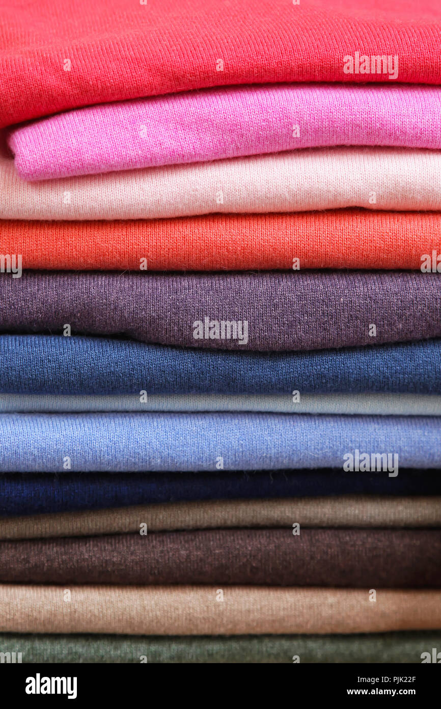 Big pile of vivid color sweaters and jumpers Stock Photo