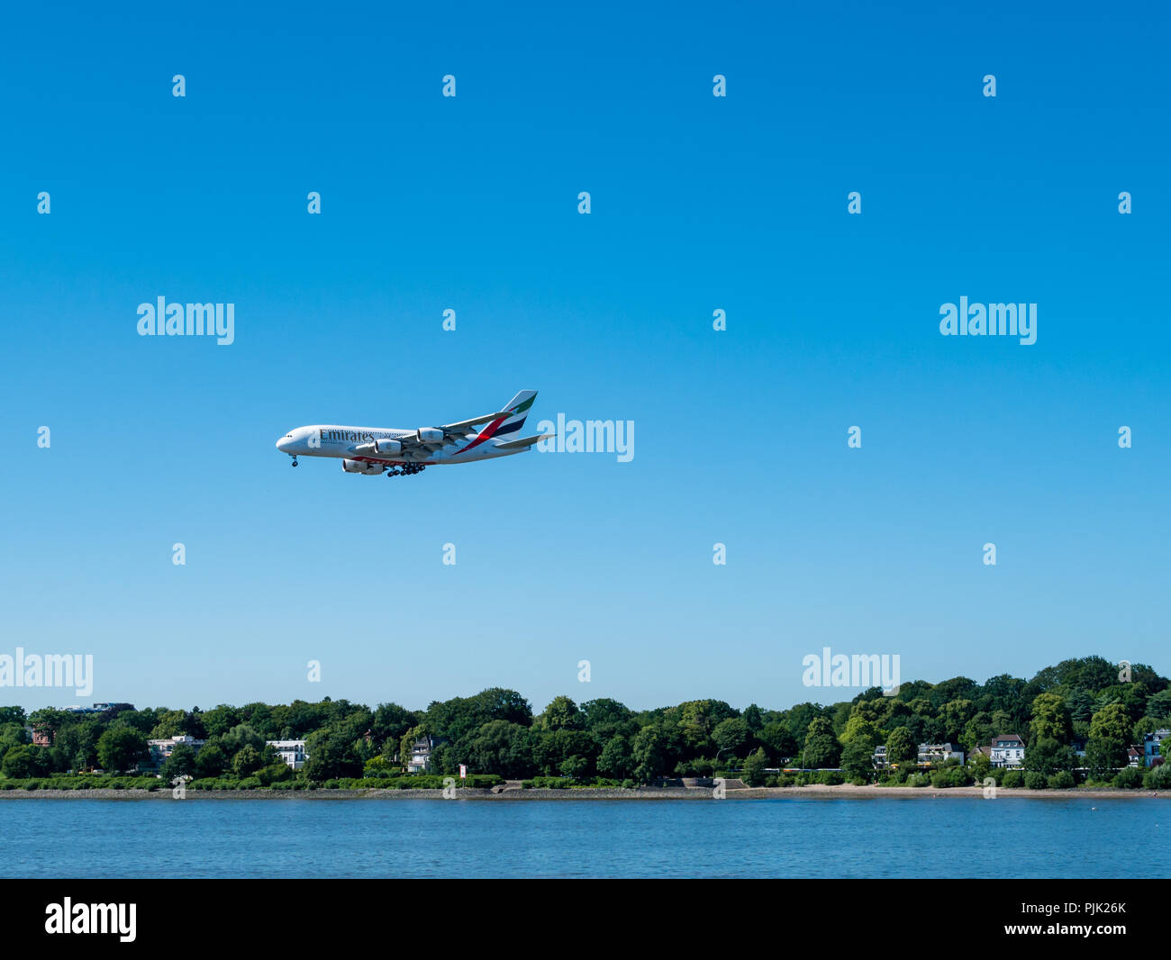 Hamburg, Germany - July 07, 2018: Airbus 380 in low level flight for landing approach at Airbus Industries at sunny day in Hamburg, Germany. Stock Photo