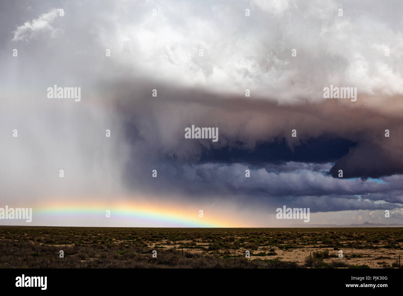 A wall cloud beneath the mesocyclone of a supercell thunderstorm with dramatic hail core in Arizona Stock Photo