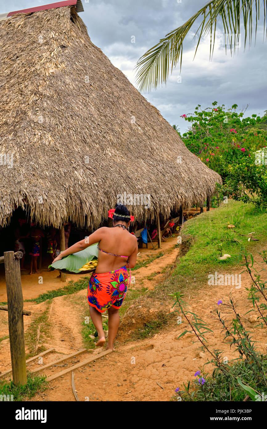 Chagres National Park, Panama - April 22, 2018: Native Embera people bringing food to visiting tourists in the tribe's hut Stock Photo