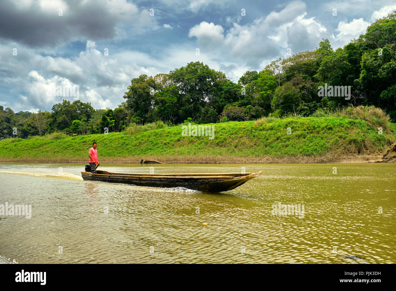 Chagres National Park, Panama - April 22, 2018: Dugout canoe steered through Rio Chagres river Stock Photo