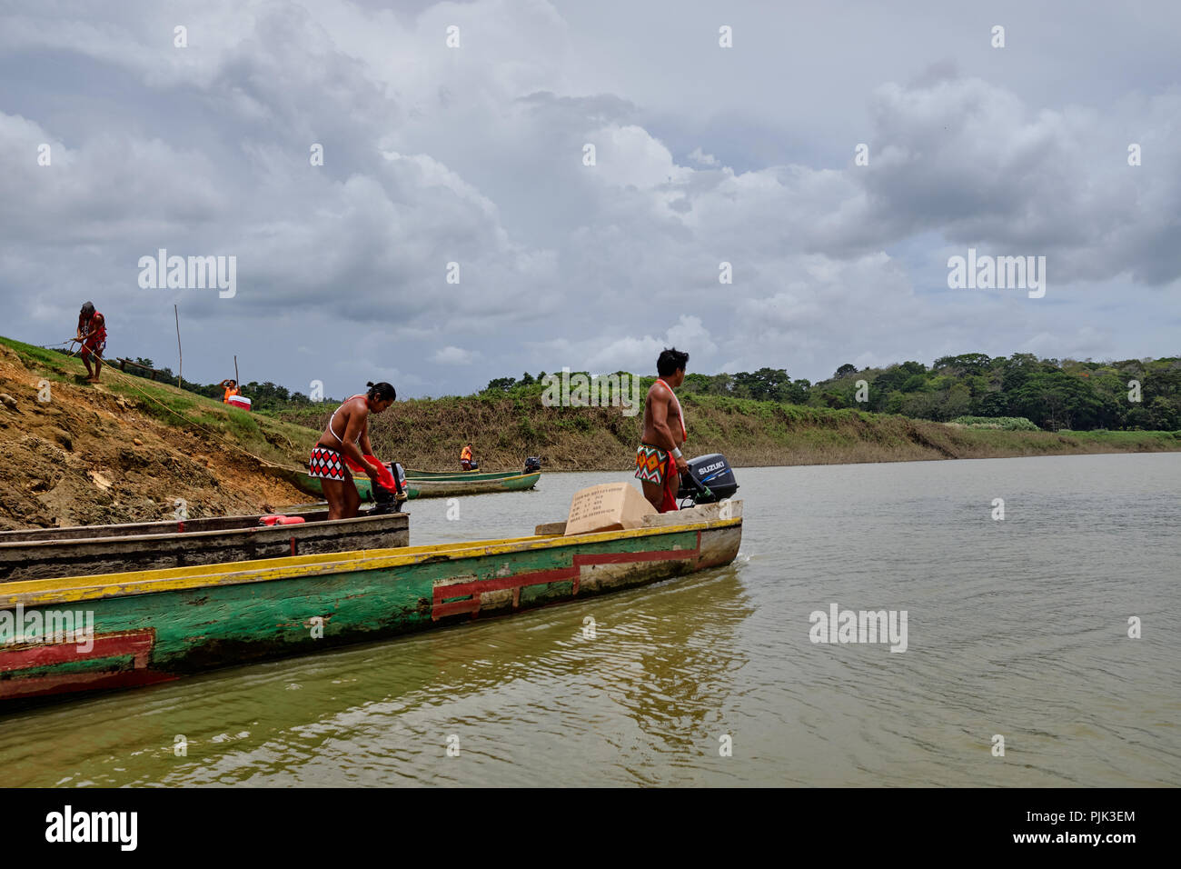 Chagres National Park, Panama - April 22, 2018: Native Embera people steering a dugout canoe along the river Stock Photo