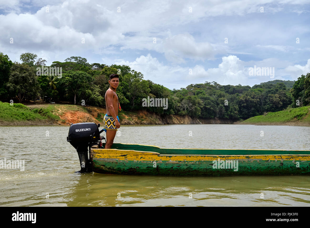Chagres National Park, Panama - April 22, 2018: Native Embera man steering a dugout canoe along the river Stock Photo